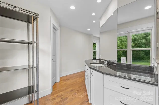 a kitchen with stainless steel appliances granite countertop a sink and a refrigerator