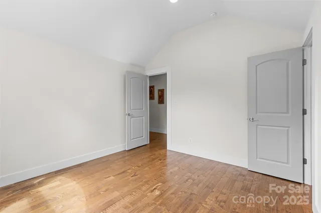 a view of an empty room and closet area