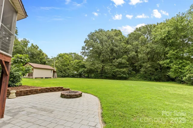 a view of a backyard with large trees