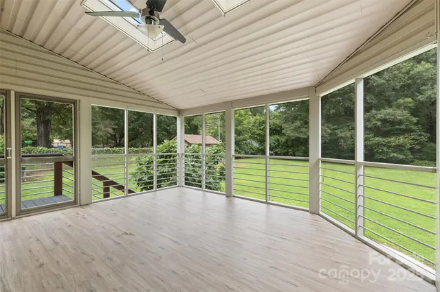 a view of a deck hardwood and floor to ceiling window