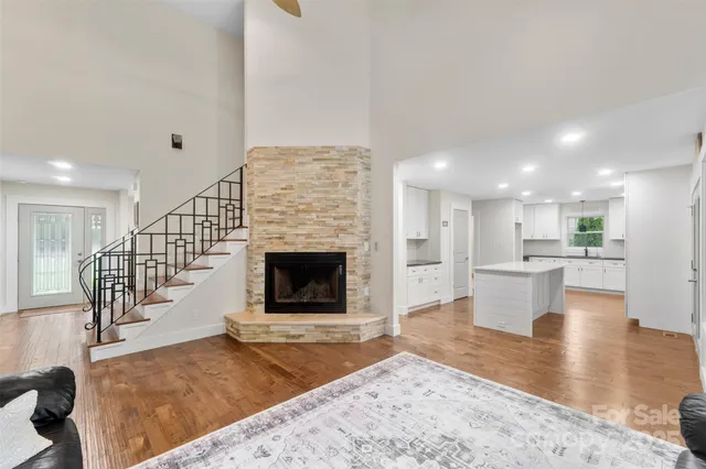 a living room with fireplace furniture and a wooden floor