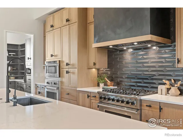 a kitchen with stainless steel appliances kitchen island wooden cabinets and a stove