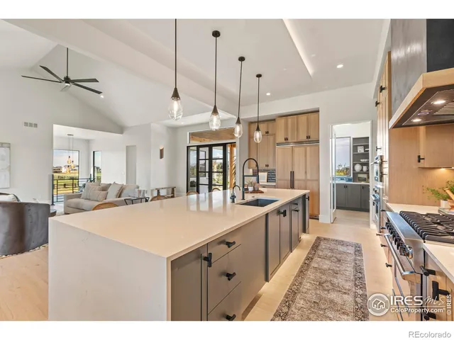 a open kitchen with kitchen island a stove a sink a center island and wooden cabinets