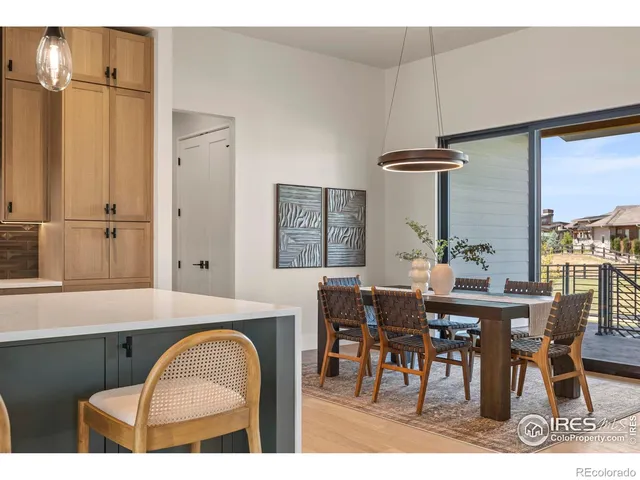 a dining room with furniture a chandelier and window