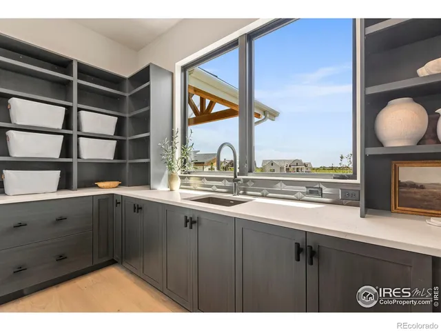 a kitchen with a sink and a large window