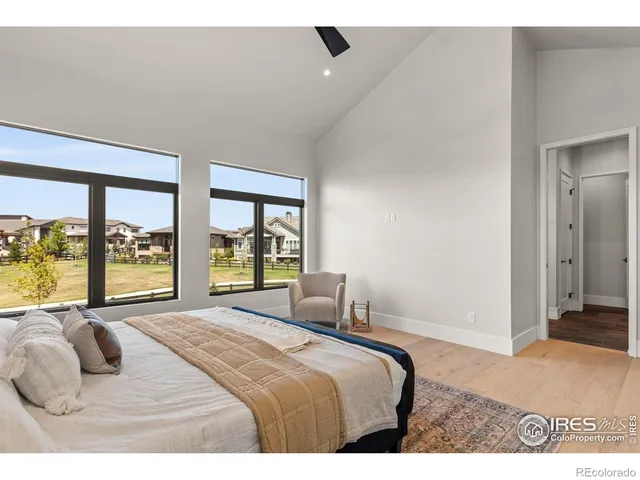 a bedroom with a large bed and a large window