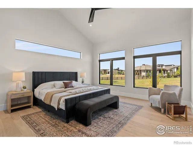 a bedroom with a large bed and a large window