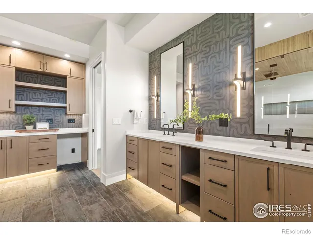 a large white kitchen with granite countertop a sink