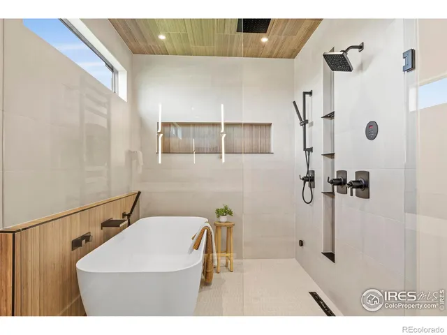 a bathroom with a sink a mirror and shower