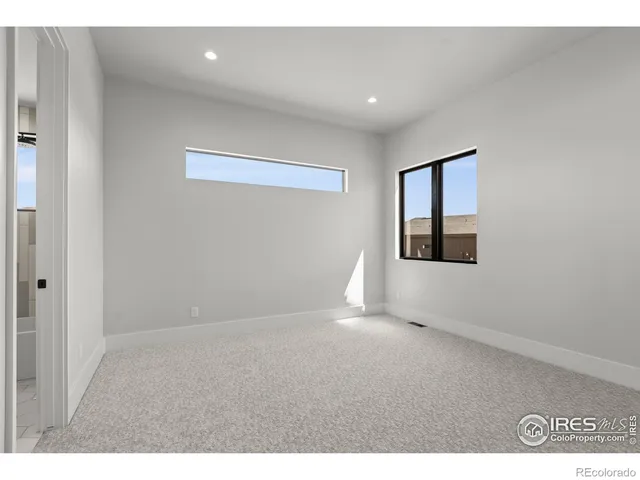 a view of an empty room with windows