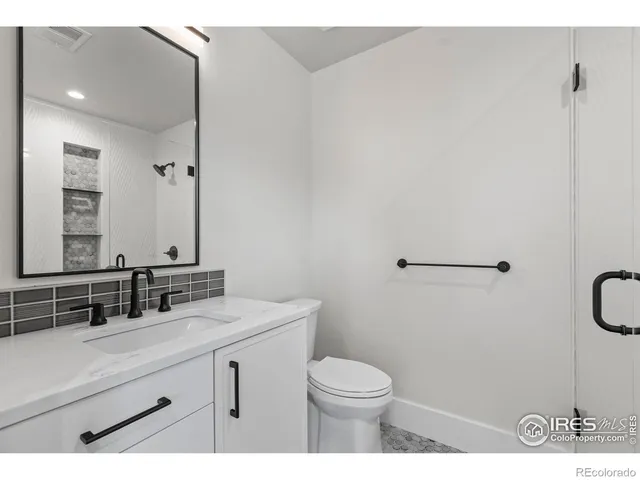 a bathroom with a sink a toilet and mirror