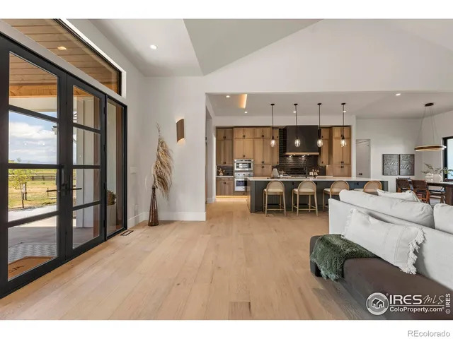 a living room with furniture and kitchen view