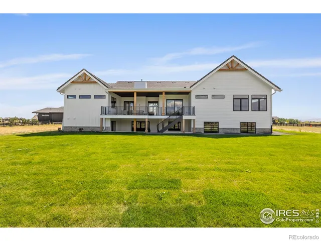 a front view of house with yard and lake view