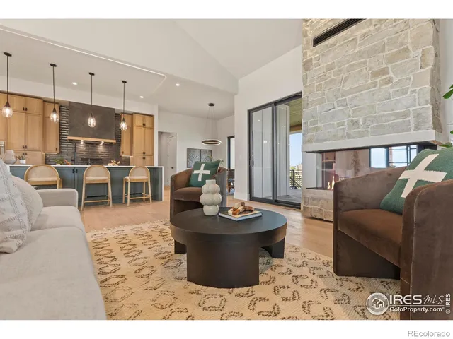 a living room with furniture and a dining table with kitchen view