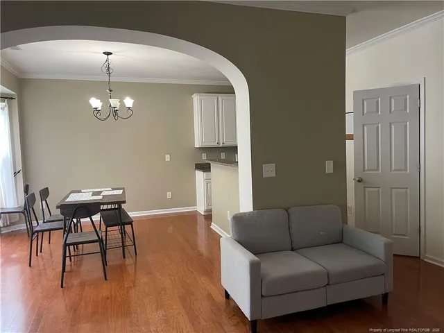a living room with furniture and a chandelier