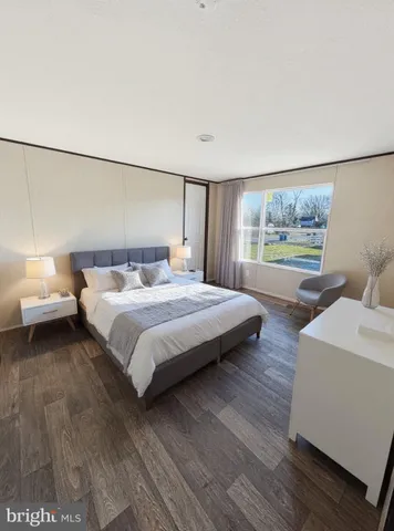 a bedroom with a bed and a large window