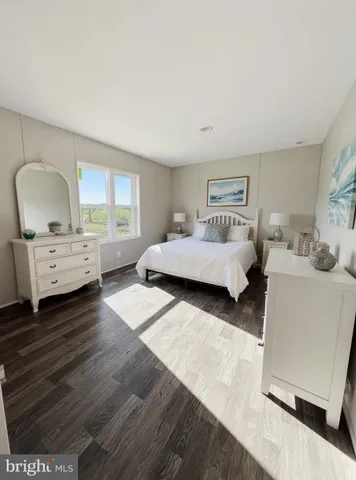 a bedroom with furniture and a wooden floor