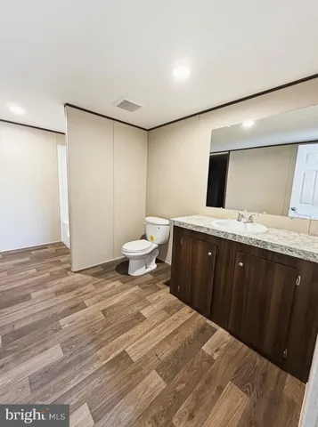 a spacious bathroom with a granite countertop sink and a mirror