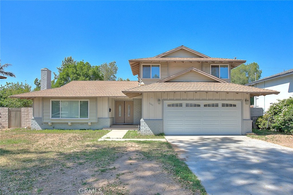 2061 Rancho Drive Riverside, CA 92507 - Photo 1 of 20 a front view of a house with a yard and garage
