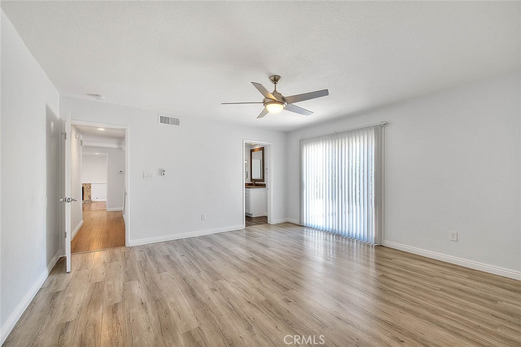 2061 Rancho Drive Riverside, CA 92507 - Photo 10 of 20 a view of an empty room with wooden floor and a window