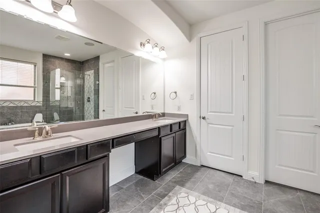 a bathroom with a double vanity sink and a mirror