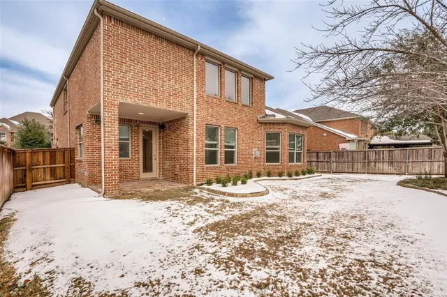 a view of a house with snow on the road