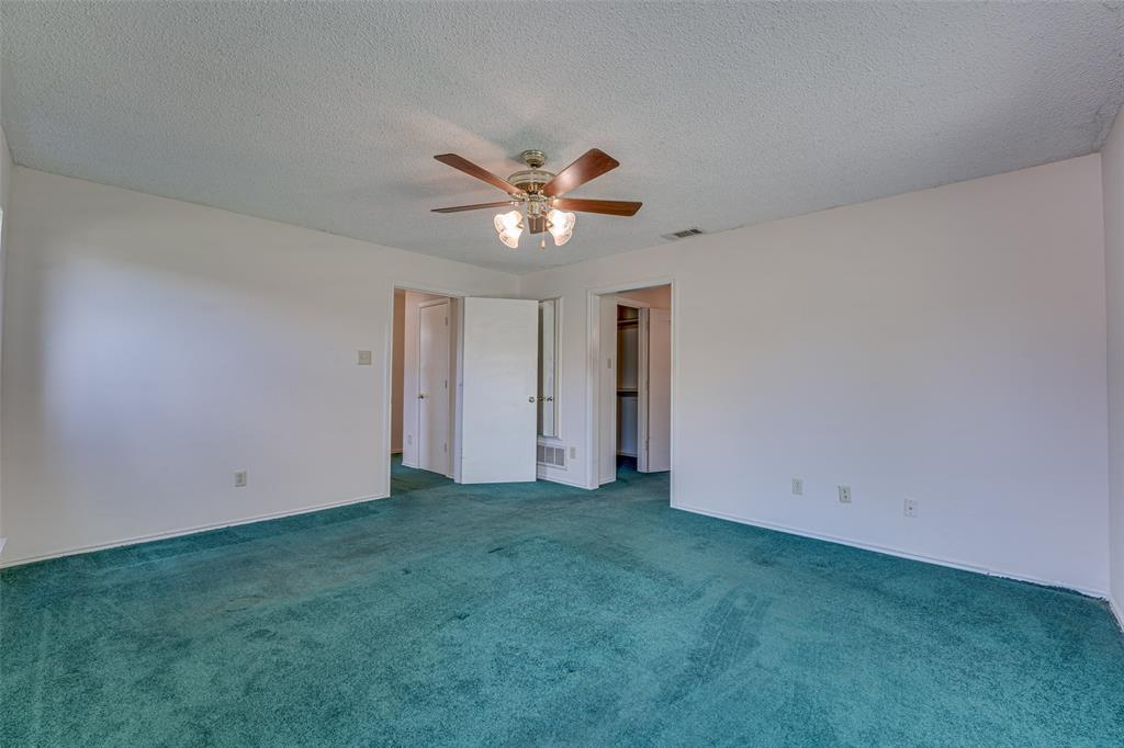 3410 Conlin Drive Rowlett, TX 75088 - Photo 19 of 27 an empty room with closet and a ceiling fan