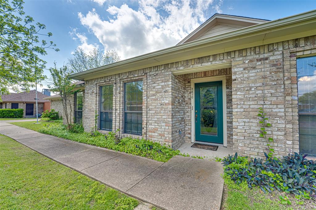 3410 Conlin Drive Rowlett, TX 75088 - Photo 2 of 27 a front view of a house with a garden