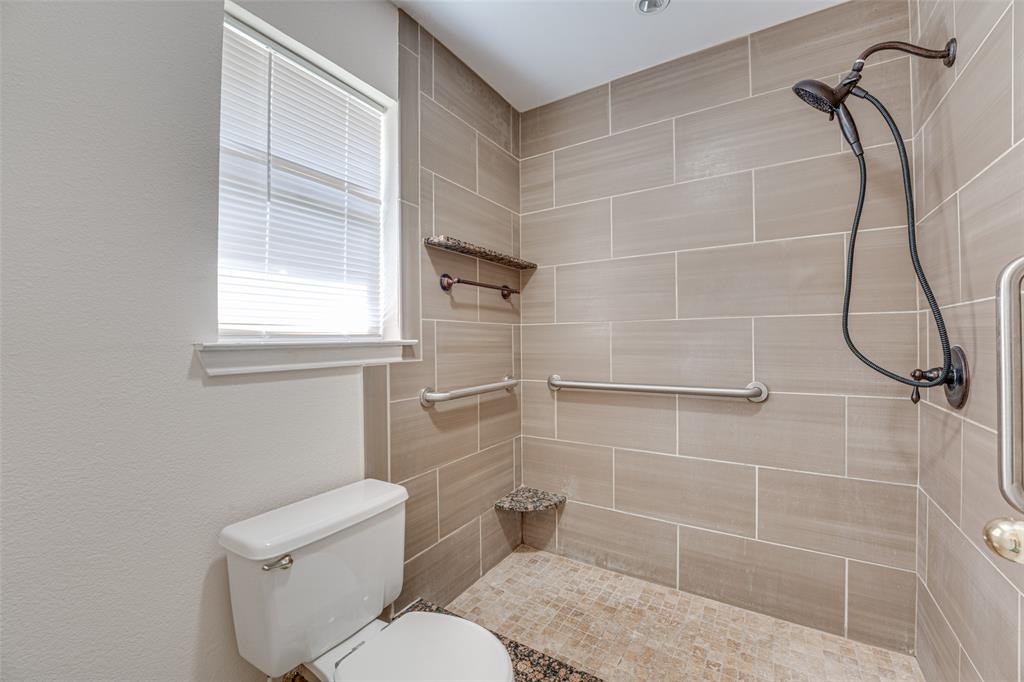 3410 Conlin Drive Rowlett, TX 75088 - Photo 21 of 27 a bathroom with a toilet and a shower