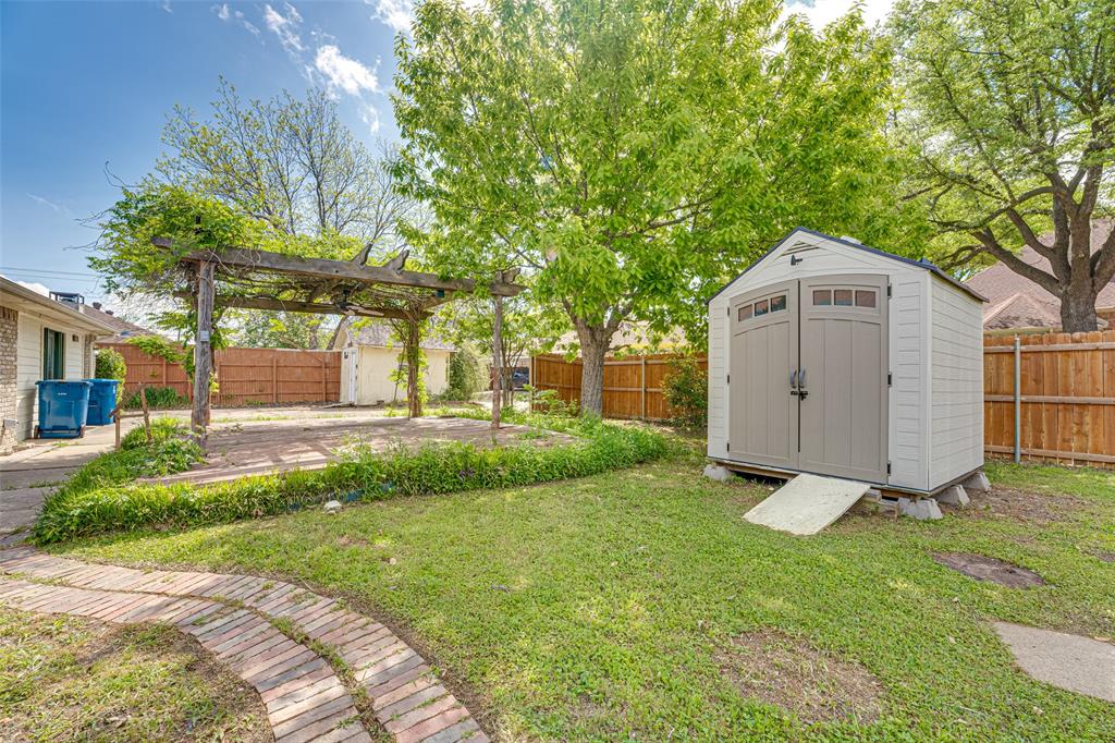3410 Conlin Drive Rowlett, TX 75088 - Photo 23 of 27 a front view of a house with a yard and garage