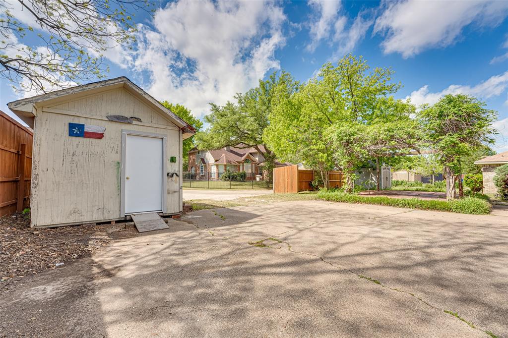 3410 Conlin Drive Rowlett, TX 75088 - Photo 25 of 27 a view of backyard of house with large trees