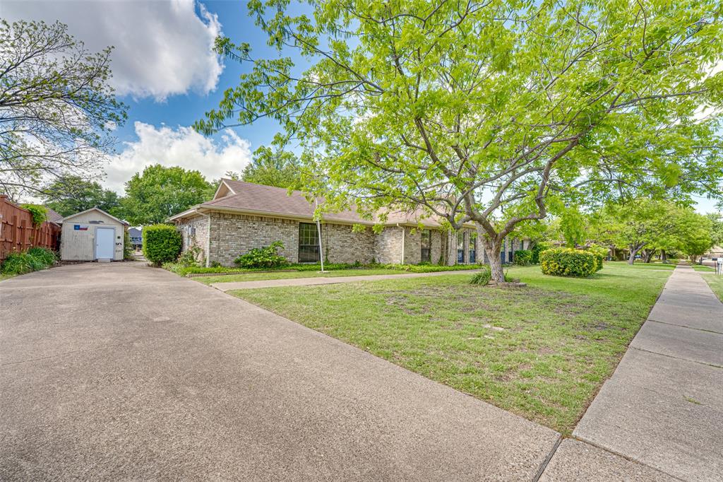 3410 Conlin Drive Rowlett, TX 75088 - Photo 3 of 27 a front view of a house with a yard and trees