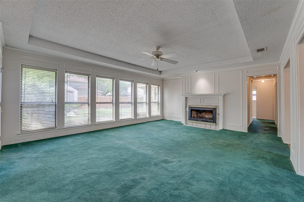 3410 Conlin Drive Rowlett, TX 75088 - Photo 5 of 27 a view of an empty room with a fireplace and a window
