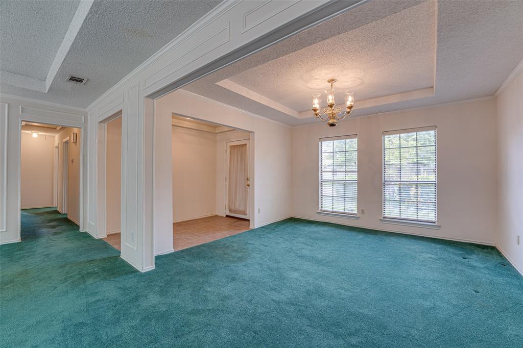 3410 Conlin Drive Rowlett, TX 75088 - Photo 6 of 27 an empty room with chandelier fan and windows