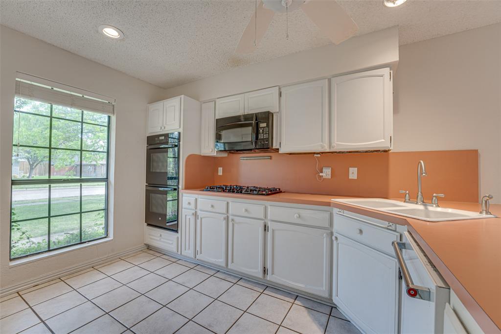3410 Conlin Drive Rowlett, TX 75088 - Photo 7 of 27 a kitchen with a sink and cabinets