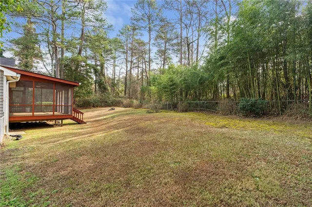 a view of a backyard with large trees