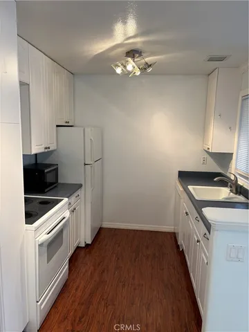 a kitchen with a sink and a stove top oven