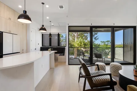 a large living room with a large window and furniture