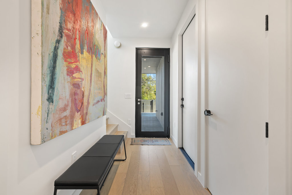 4707 Reyes Street, Unit 2 Austin, TX 78721 - Photo 12 of 33 a view of a hallway with wooden floor and staircase