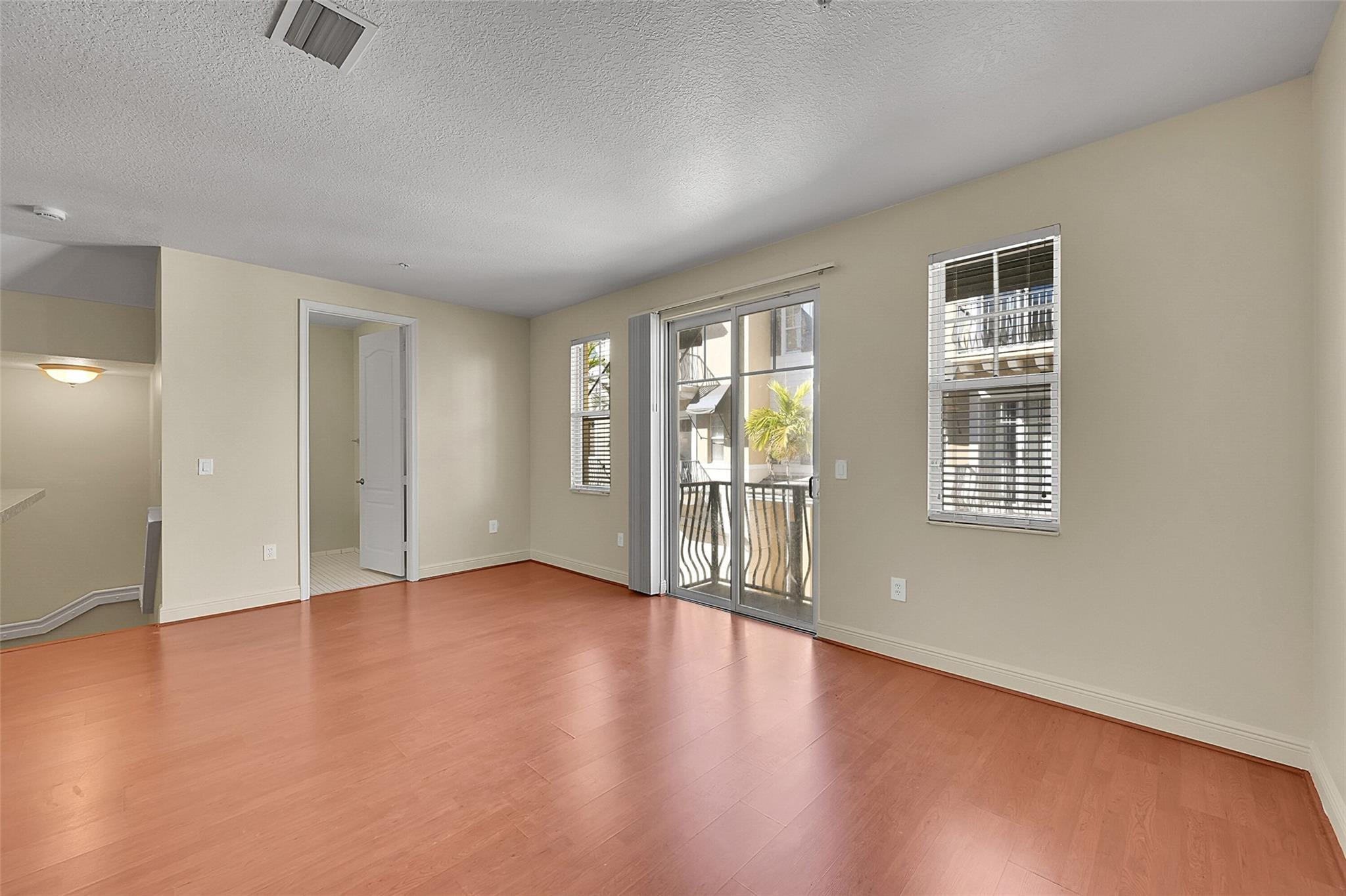 3605 Northwest 5th Terrace Boca Raton, FL 33431 - Photo 11 of 48 an empty room with wooden floor and windows