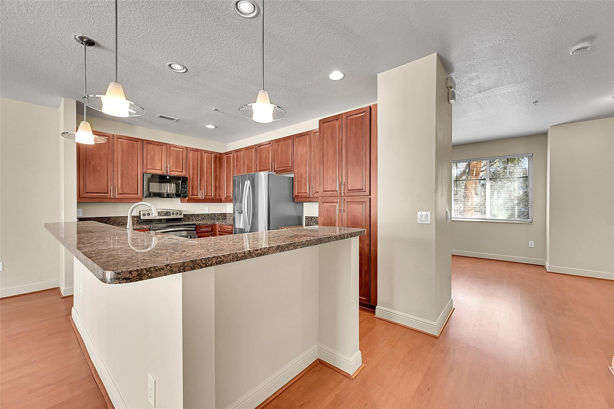 3605 Northwest 5th Terrace Boca Raton, FL 33431 - Photo 13 of 48 a kitchen with stainless steel appliances granite countertop a refrigerator a sink dishwasher a stove and white countertops with wooden floor