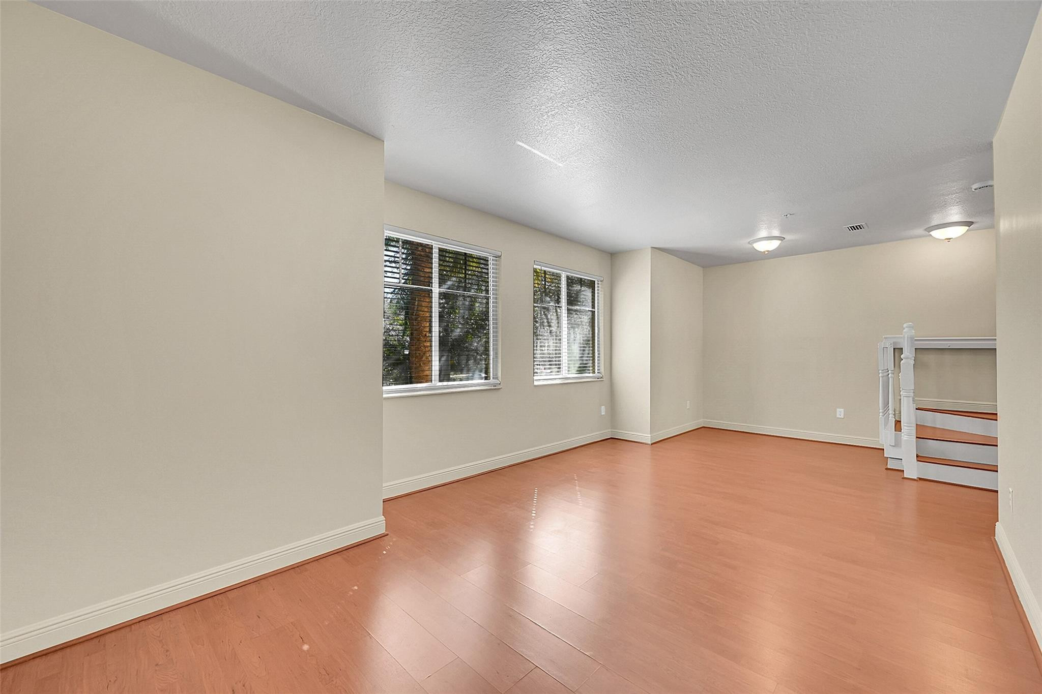 3605 Northwest 5th Terrace Boca Raton, FL 33431 - Photo 19 of 48 an empty room with wooden floor and windows