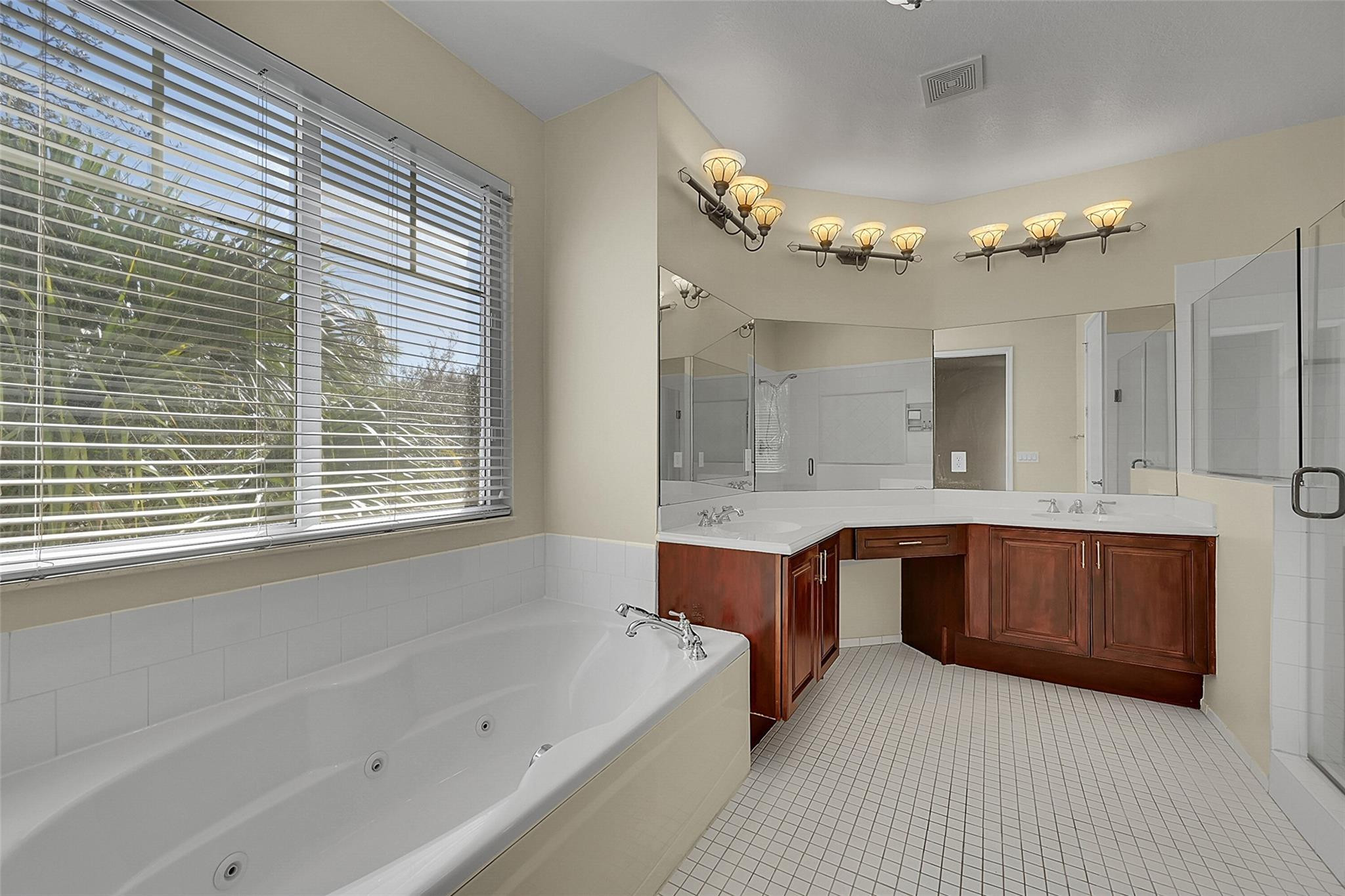 3605 Northwest 5th Terrace Boca Raton, FL 33431 - Photo 31 of 48 a spacious bathroom with a tub a double vanity sink and a large mirror