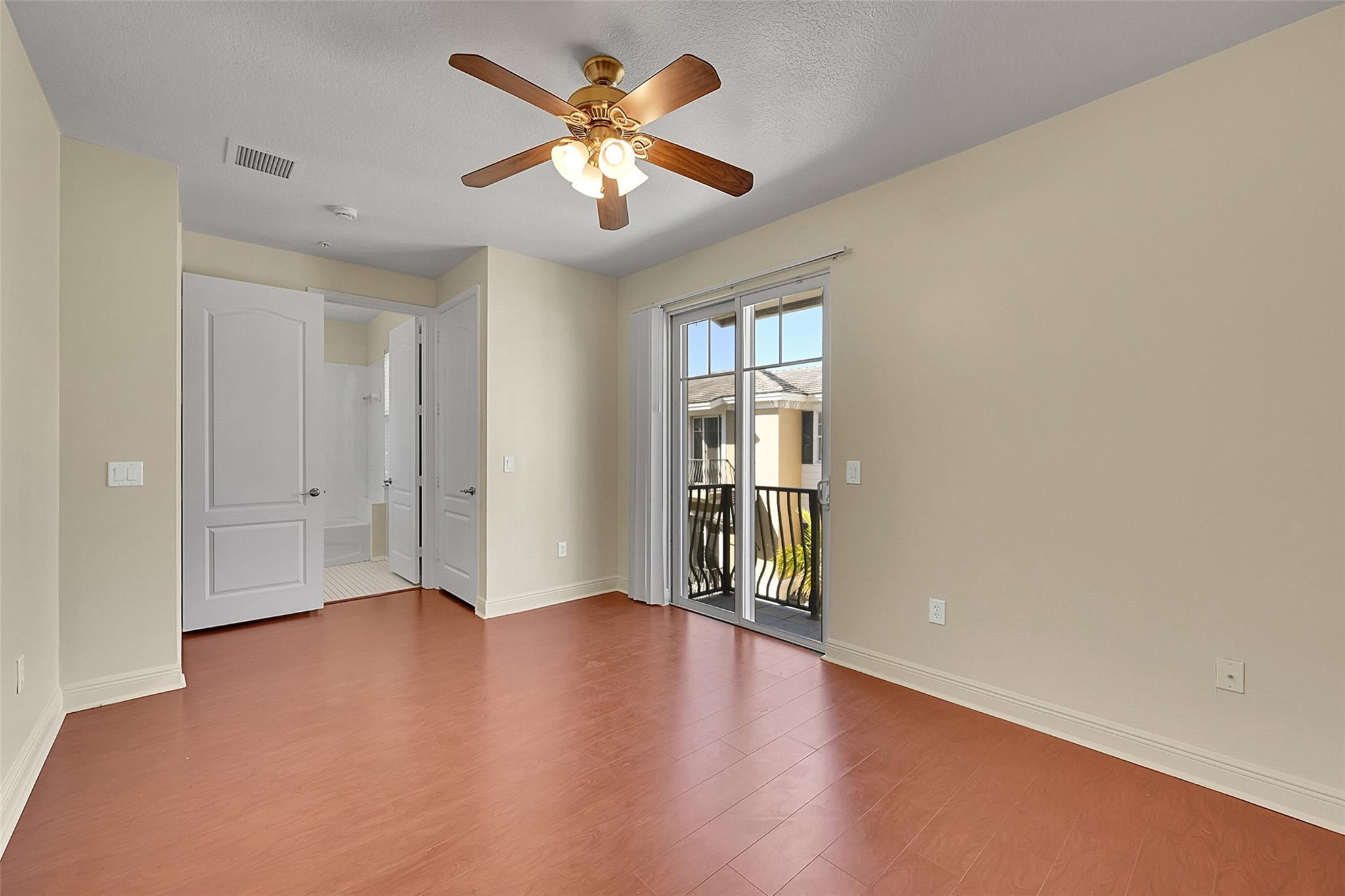 3605 Northwest 5th Terrace Boca Raton, FL 33431 - Photo 33 of 48 an empty room with wooden floor and windows