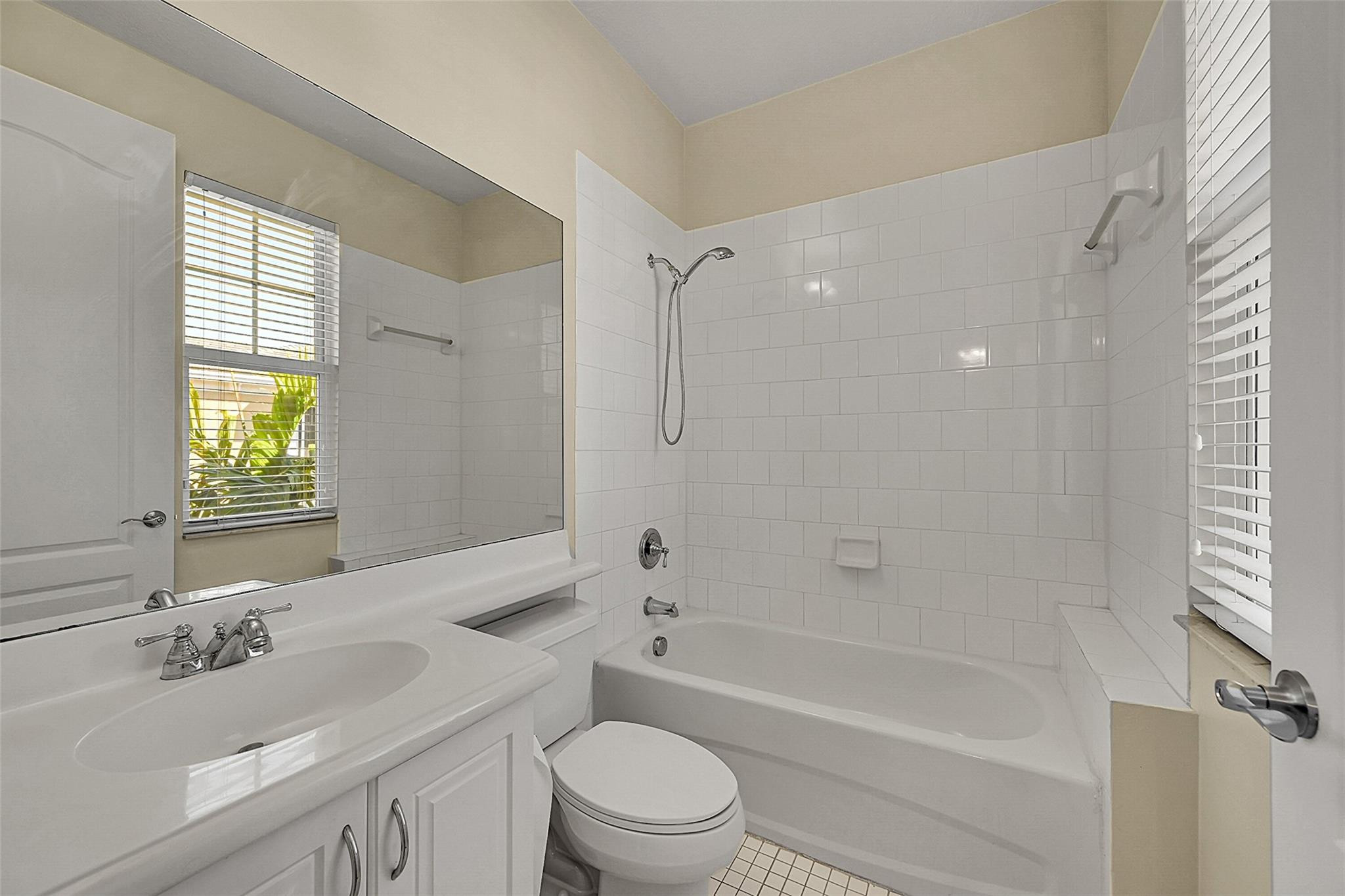 3605 Northwest 5th Terrace Boca Raton, FL 33431 - Photo 35 of 48 a bathroom with a bathtub shower sink vanity mirror and toilet