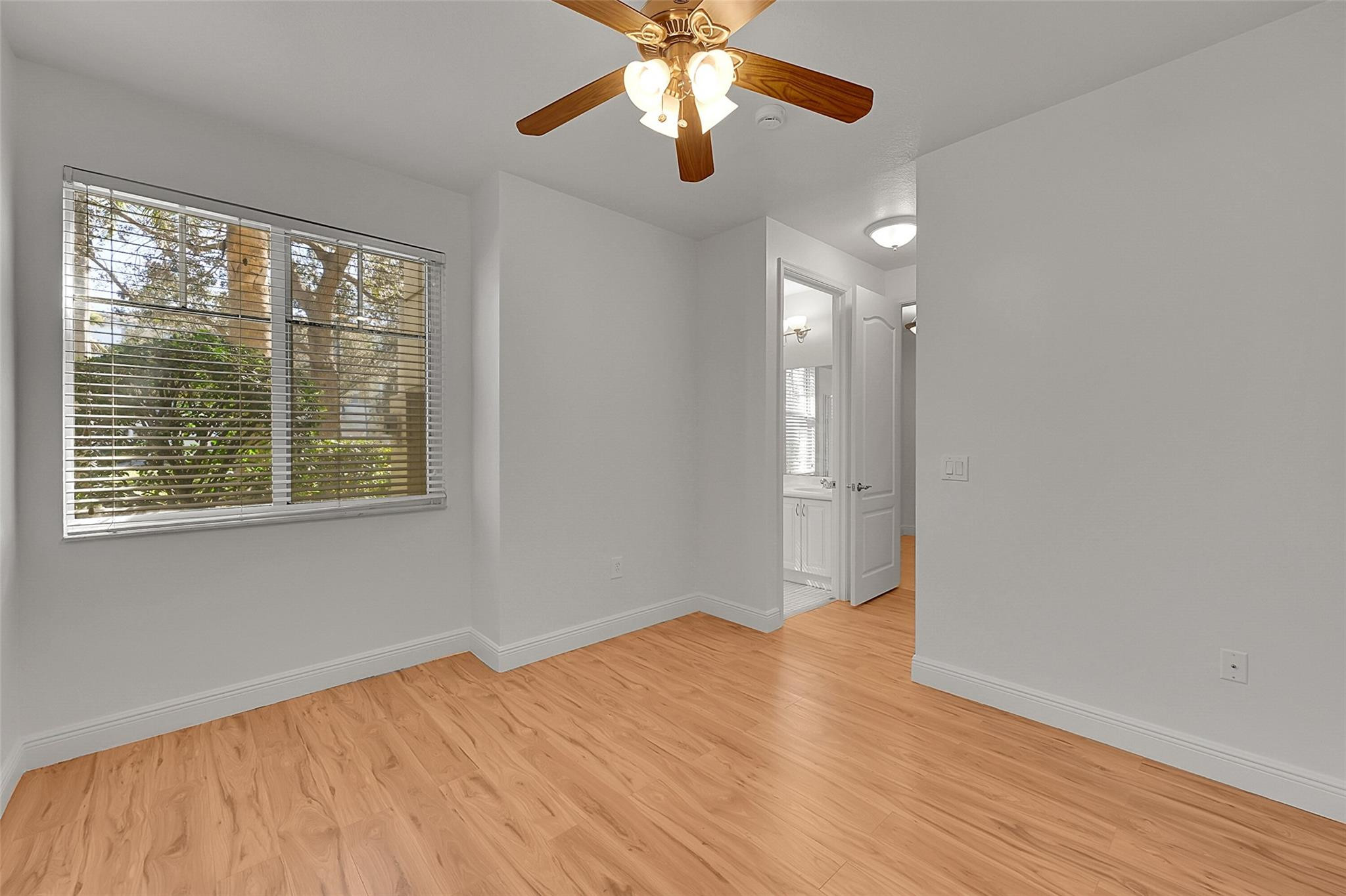 3605 Northwest 5th Terrace Boca Raton, FL 33431 - Photo 37 of 48 a view of empty room with wooden floor and fan