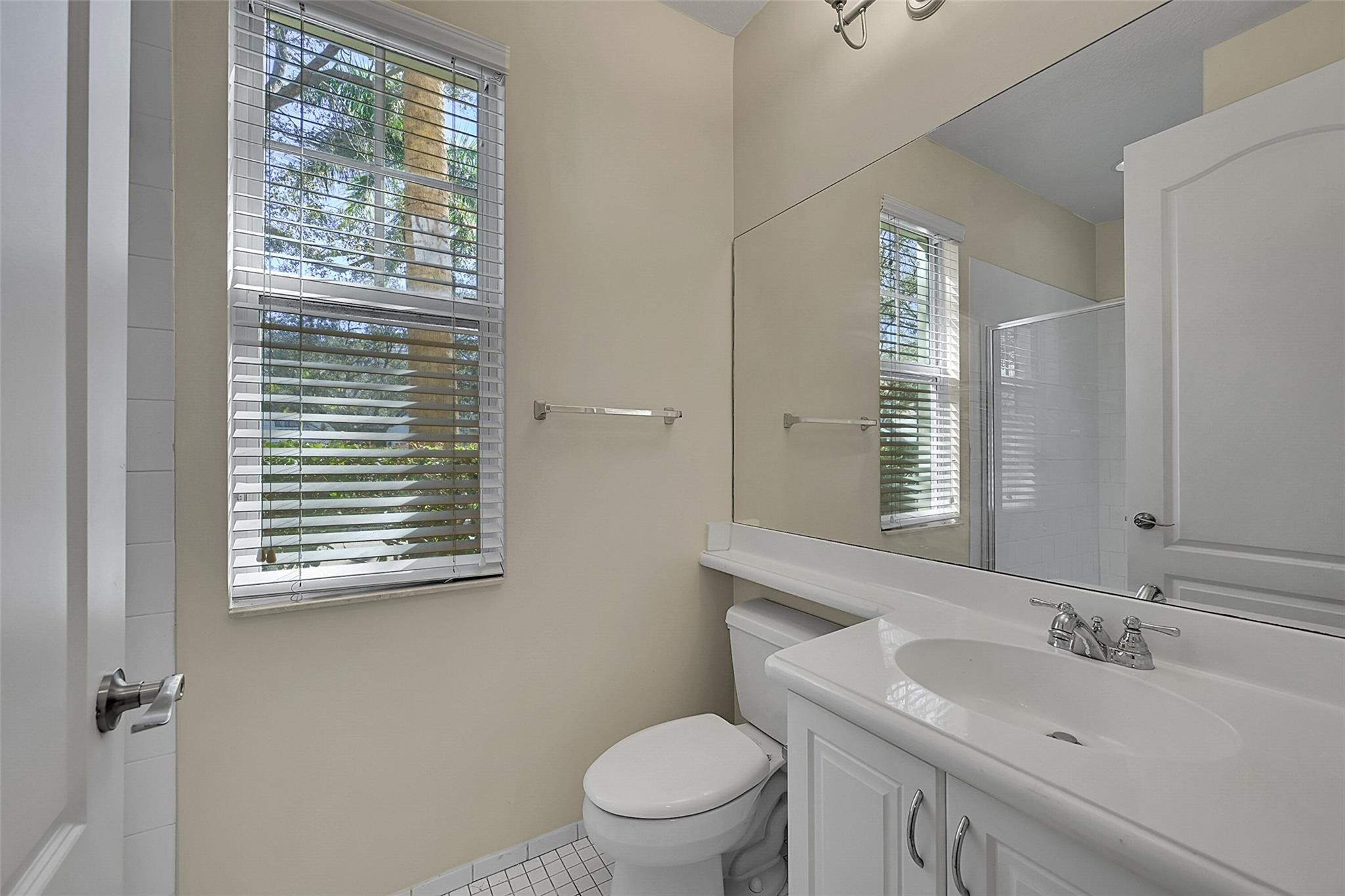 3605 Northwest 5th Terrace Boca Raton, FL 33431 - Photo 38 of 48 a bathroom with a sink a toilet and a mirror