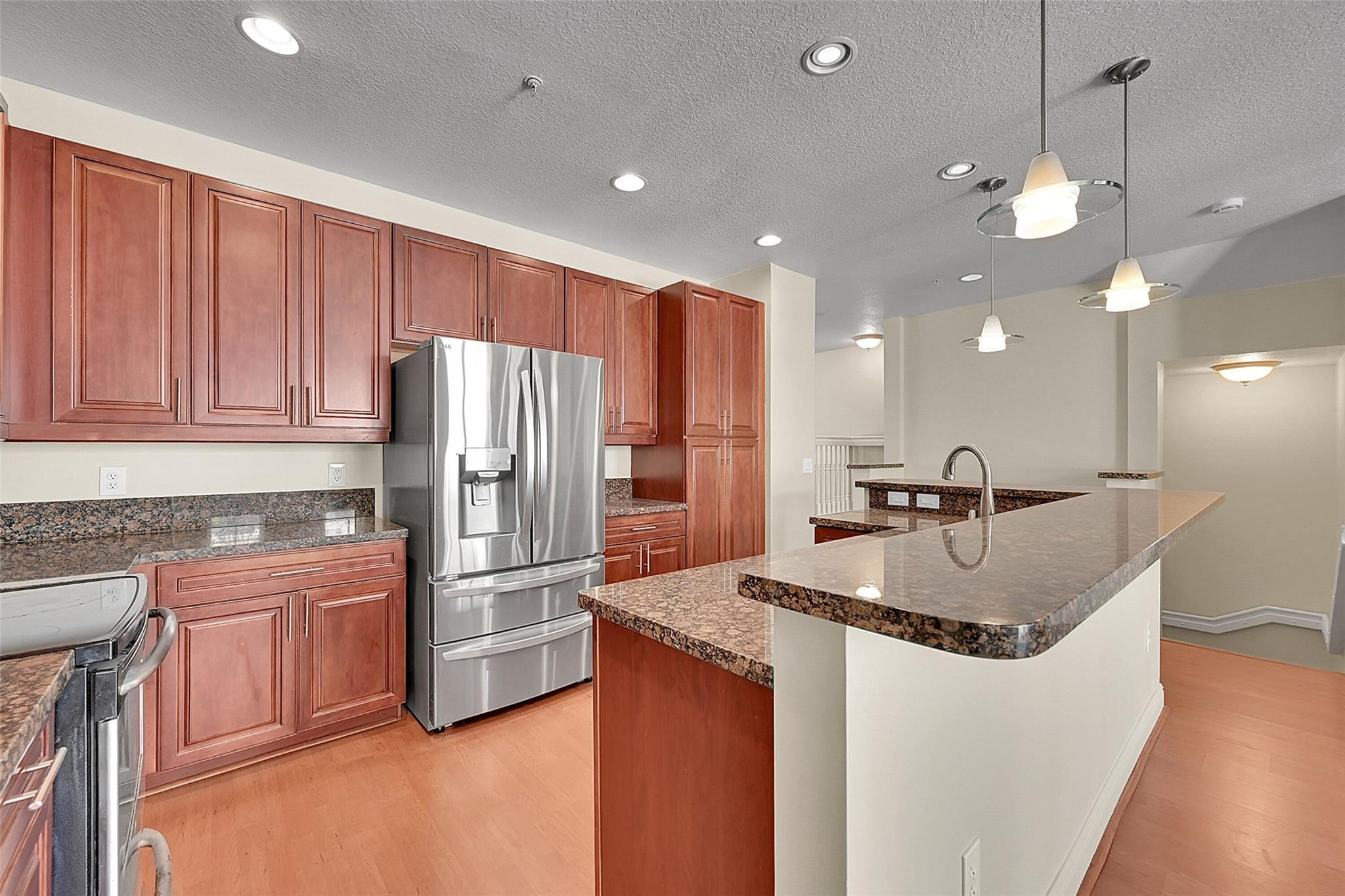 3605 Northwest 5th Terrace Boca Raton, FL 33431 - Photo 4 of 48 a kitchen with stainless steel appliances granite countertop a sink a refrigerator and a stove