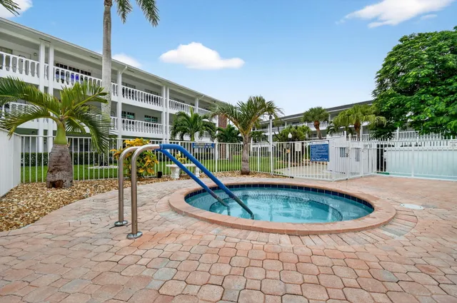 a view of a house with a swimming pool and sitting area