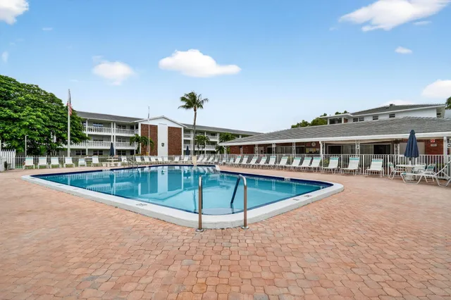a view of a swimming pool with an outdoor seating